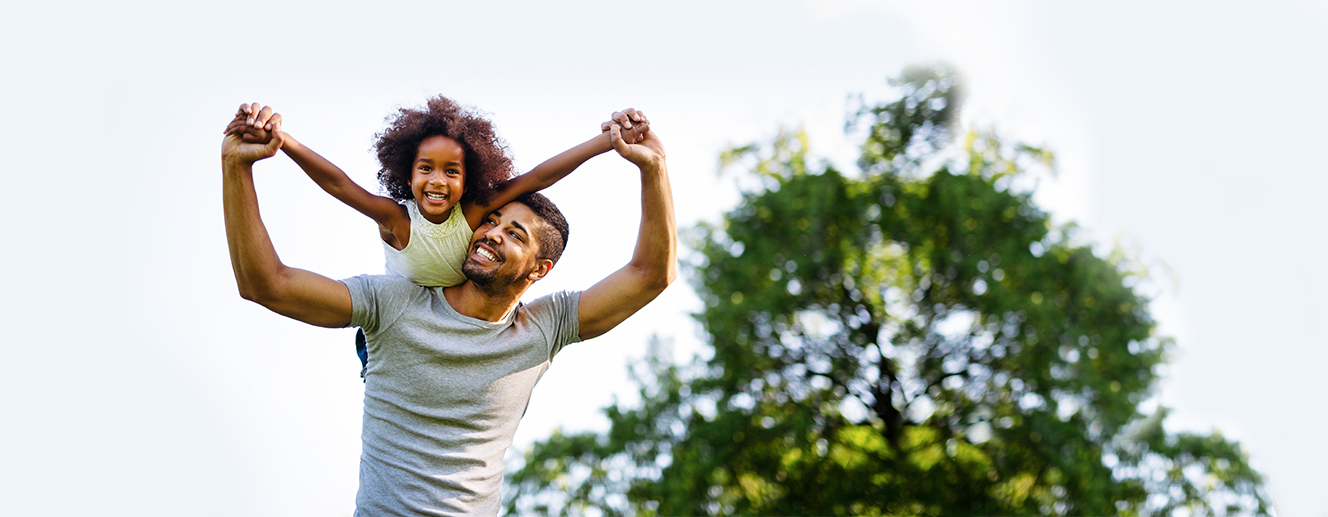 Father carrying happy daughter above his head