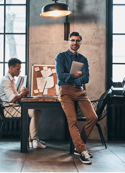 Man standing near desk discussing PEO services Man standing near desk discussing PEO services