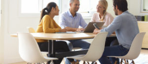 Employees sitting around a table