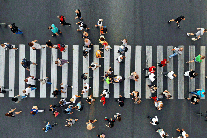 Overhead of people walking over a crosswalk