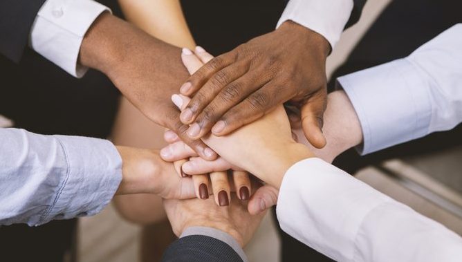 Employees creating a hand-stack