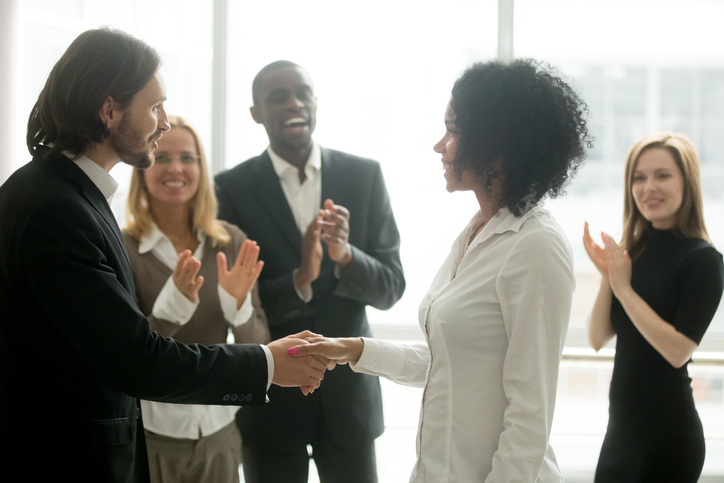 Grateful boss handshaking promoting african businesswoman congratulating with career achievement Defining Diversity, Equity, and Inclusion