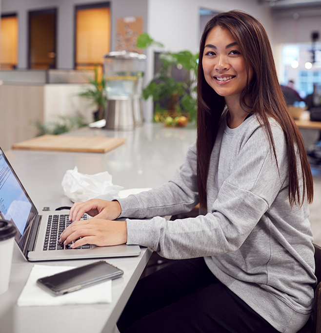 Employee smiling in an office workspace