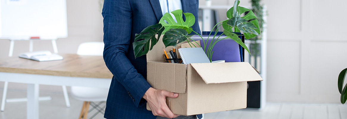 102721_Unemployment_Tips_Blog_Image Now unemployed person moving their belongings out of an office