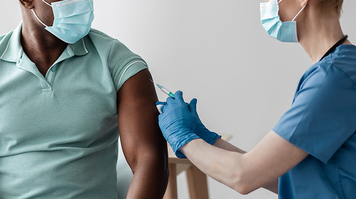 A doctor administrating a shot to a patient's arm