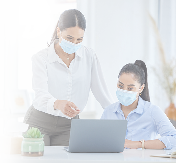 Masked employee helping another masked employee