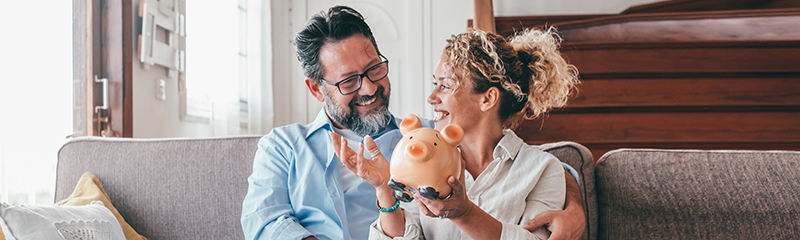 Retirement Plan deadline - Couple saving with a piggy bank
