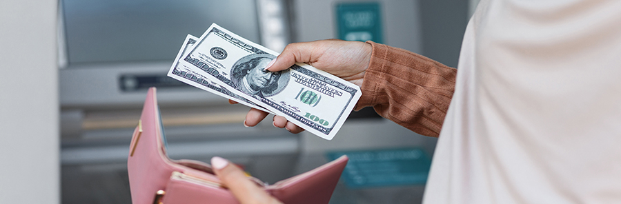 female holding money and wallet