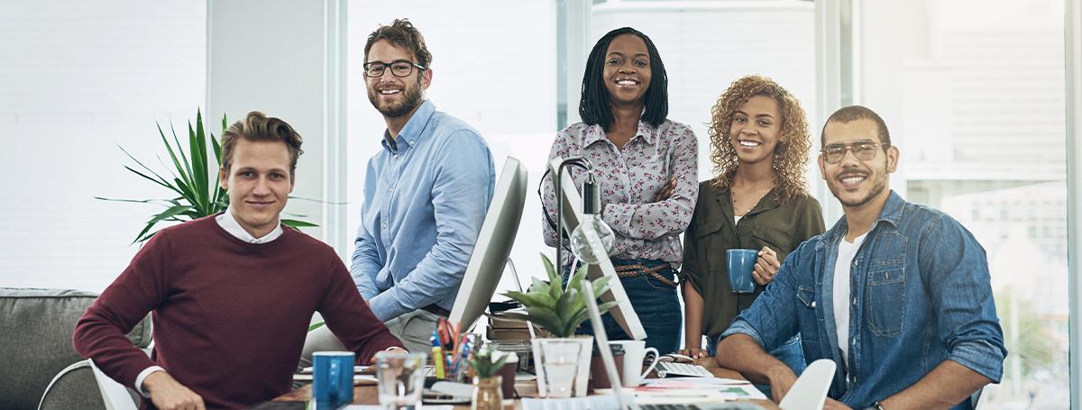 111824 - The Long-Term Value of Employee Benefits Investments Header Image Happy office staff looking at camera