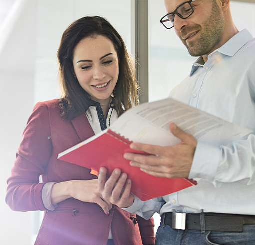 Compliance and Risk Management - Employee Handbook Business People reviewing employee handbook