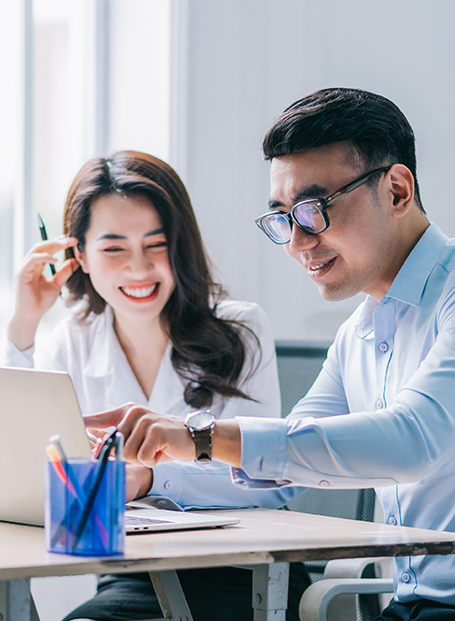 Two,Asian,Businesspeople,Working,At,Office Business associates learning what is a PEO